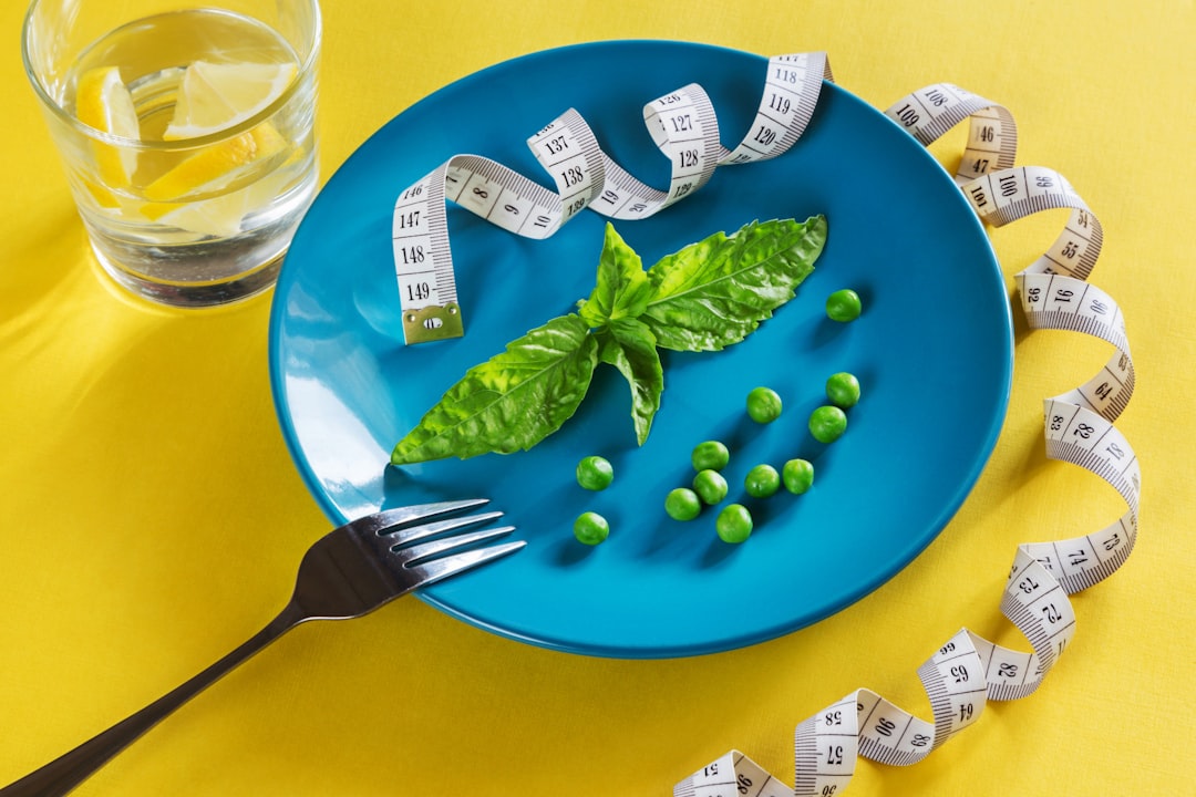 Healthy plate and measuring tape representing weight loss and diet changes discussed in gout management.