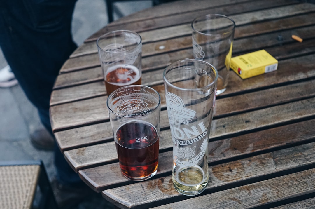 Beer, wine, and spirits on a table representing alcohol and gout flare risk.