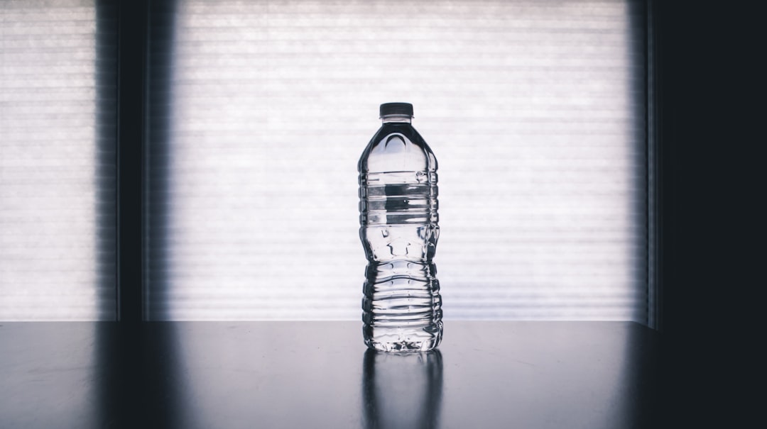 Clear bottle of water representing hydration in gout management.